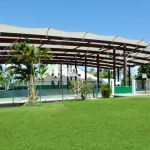 Construction of a covered basketball court with mixed woodworking storage glue and galvanized steel and textile membrane cover, Vauclin (Martinique)