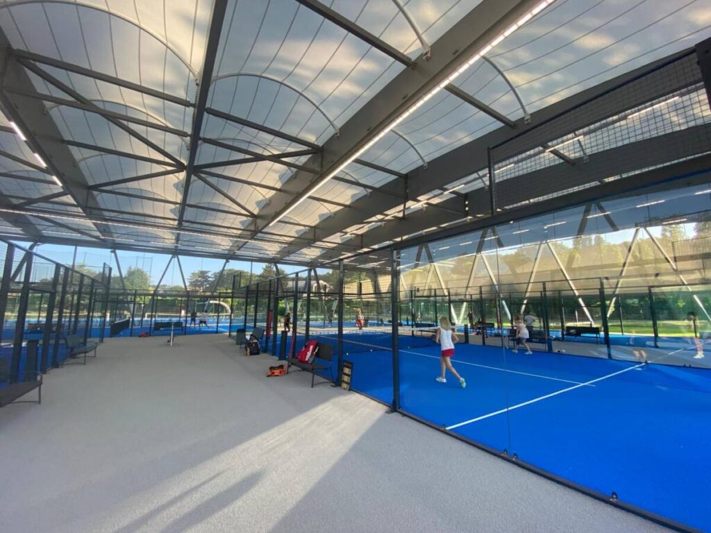 SMC2 covered five padel courts at Les Pyramides Club (Le Port-Marly) with a grey steel-and-timber structure and a durable, elegant textile membrane.