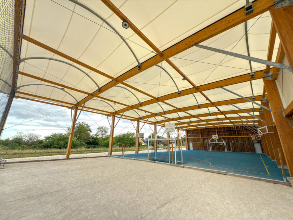 Construction of a multisport préau in Sarlat-la-Canéda, France.