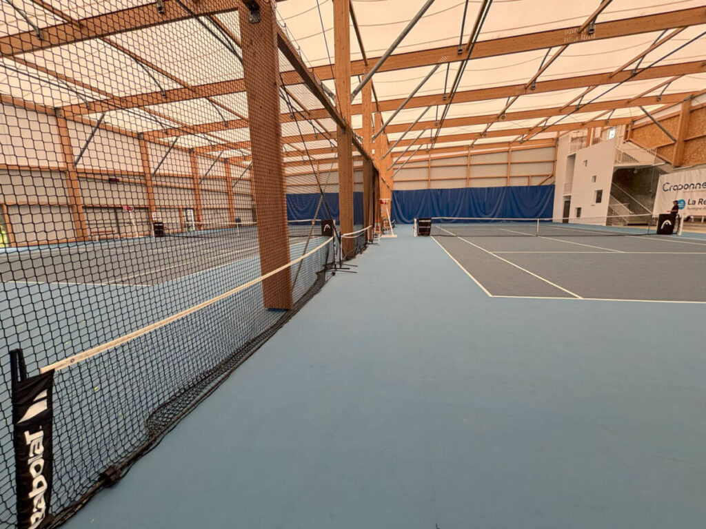 Construction of a 1,400 sp ft indoor tennis court: glued-laminated timber frame, textile membrane and high-performance sports floor.