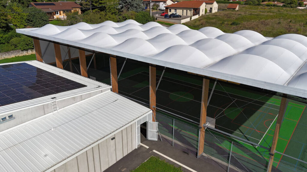 Construction of a complex in Lucenay (France): sports hall with textile membrane and wooden frame, with annexes.