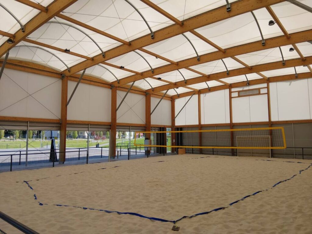 Tensile fabric and wood frame for this sports canopy in Germany