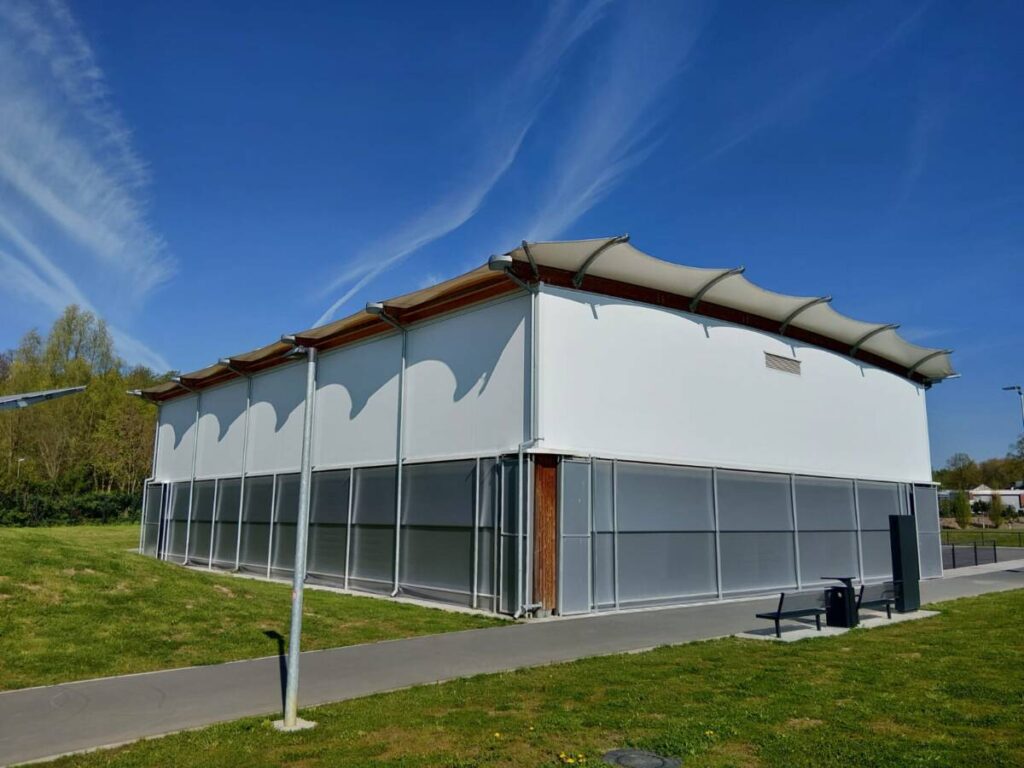 Tensile fabric and wood frame for this sports canopy in Germany