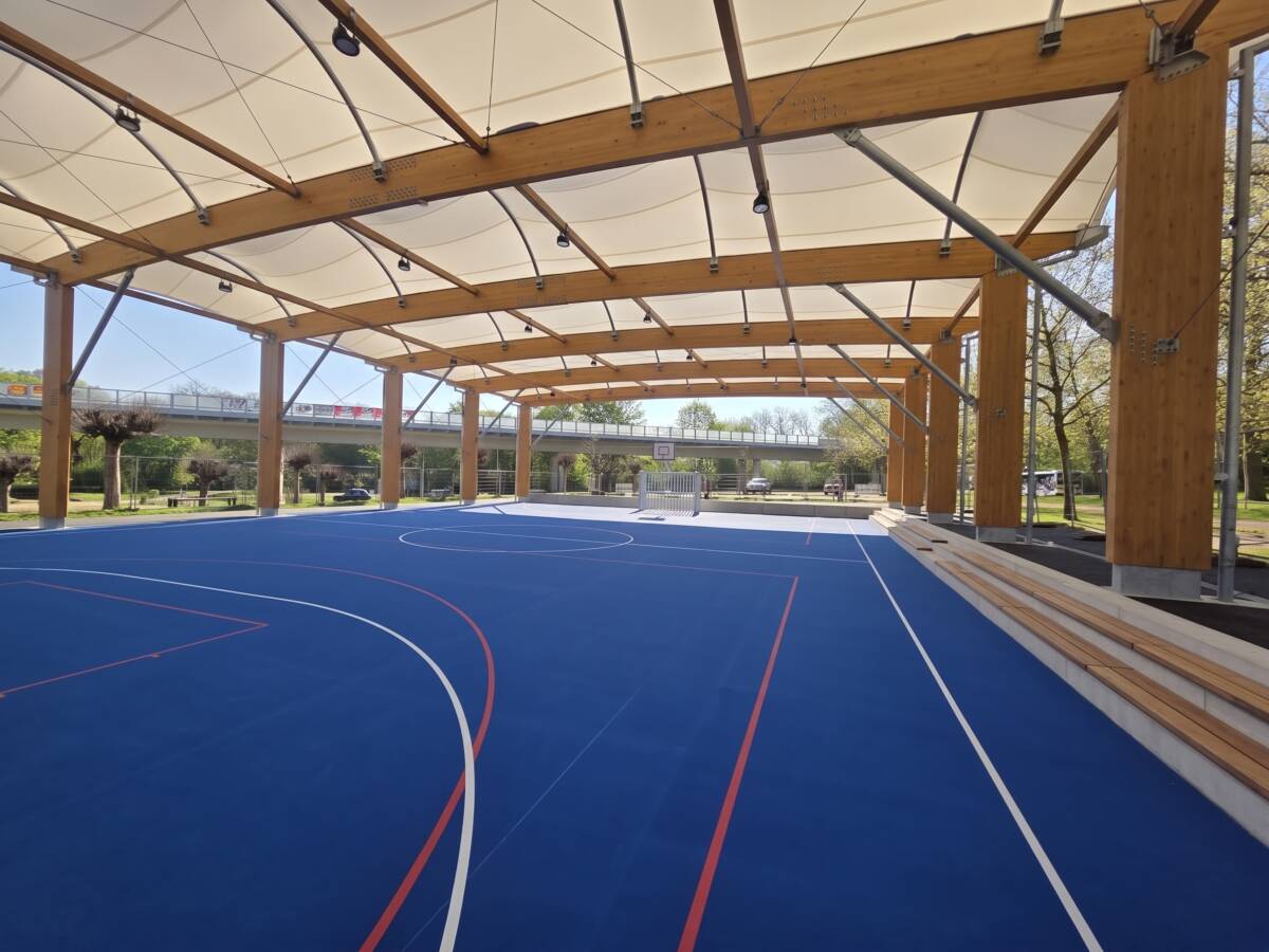 EPDM surface with basketball and handball markings under the tensile membrane roof